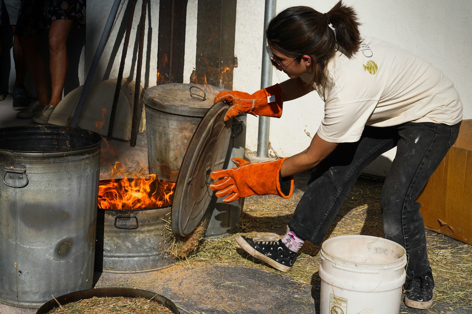 a woman in a white shirt and orange gloves